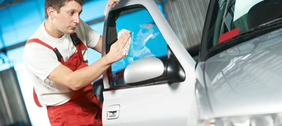 Man wiping the car window